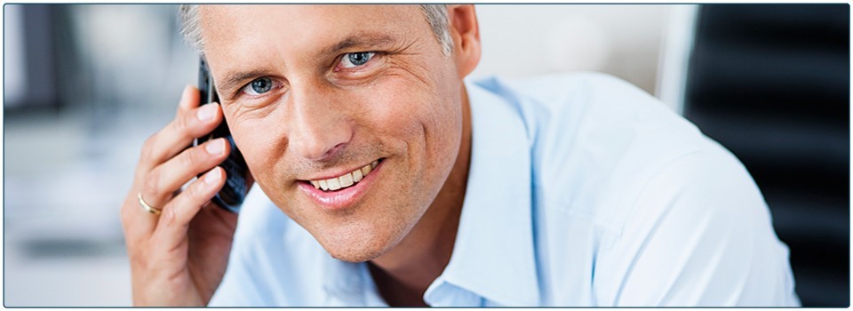 Smiling white male wearing a light blue shirt.